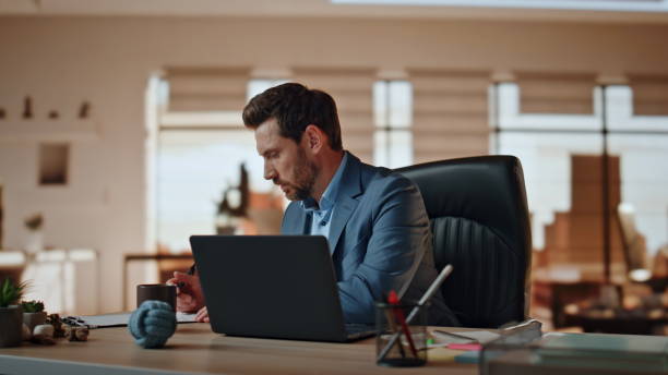istock Focused manager writing notes at light workplace closeup. Man making coffee sip 2118175758
