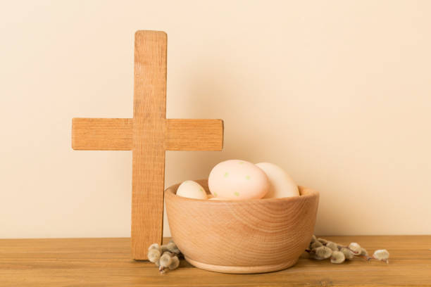 istock Easter eggs with cross on wooden background 2118202411