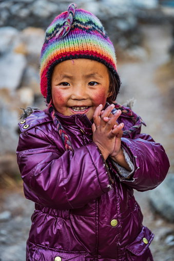 Tibetan little boy saying namaste, Sherpa village in Mount Everest National Park. This is the highest national park in the world, with the entire park located above 3,000 m ( 9,700 ft). This park includes three peaks higher than 8,000 m, including Mt Everest. Therefore, most of the park area is very rugged and steep, with its terrain cut by deep rivers and glaciers.