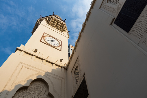 Abdulla Ali Yateem Mosque square minaret with four clocks and decorate with muqarnas in Manama Bahrain