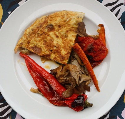 Savor the delightful combination of oven-roasted veggies paired with a fluffy omelette