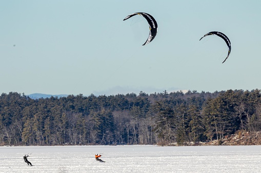 Many have heard of parasailing, but fewer have seen the art of paraskiing, where skiers glide across frozen winter lakes, pulled by the wind.  These skiers enjoy the beautiful scenery of the mountains in Western Maine.
