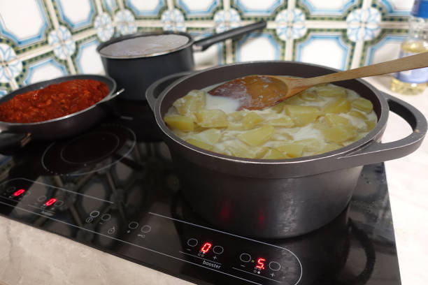 istock Mashed potatoes being cooked in milk   Bolognese sauce and boiling water on a ceramic hob 2118258435