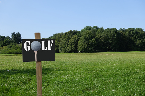Golf course in the Paris region  Sign on which is written Golf with a golf ball  Text space  Spring season