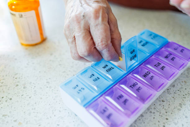 istock Weekly pill dose. Senior woman organizing medication for weekly intake 2118272368