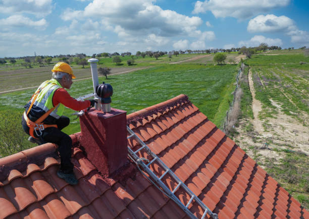 Worker doing roof repair with safety.