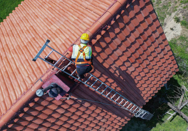 Worker doing roof repair with safety.
