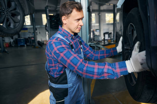 istock Engineer in tire fitting preparing for automobile repair 2118278609