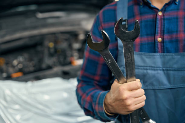 istock Mechanic with instruments for repair in tire fitting 2118278618