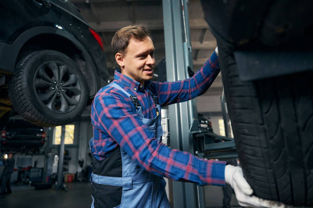 istock Worker in tire fitting preparing for automobile repair 2118278632