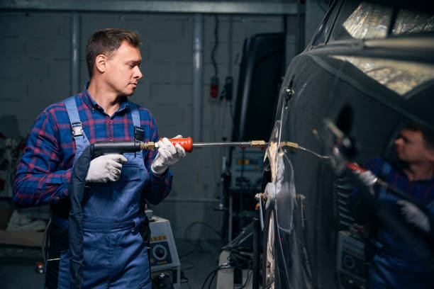istock Man working with front fender in tire fitting 2118278638