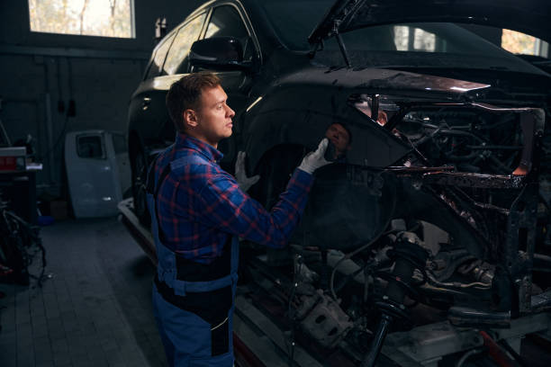 istock Young man installing fender on vehicle frame 2118278651