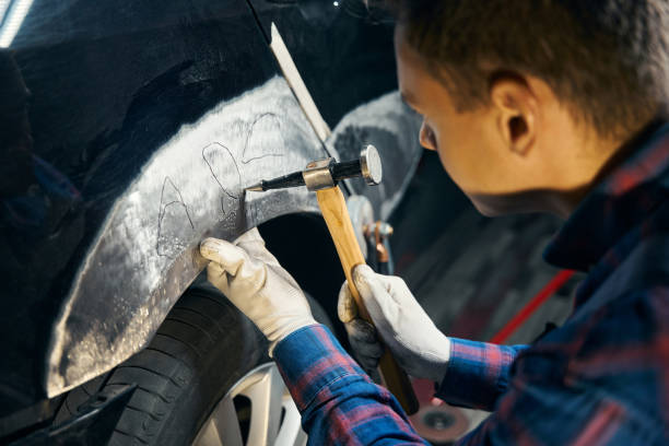 istock Skilled man working with front fender with instrument 2118278665