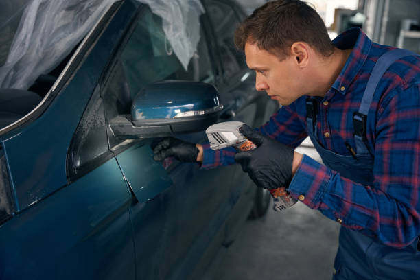 istock Worker with instrument select color for car painting 2118279206