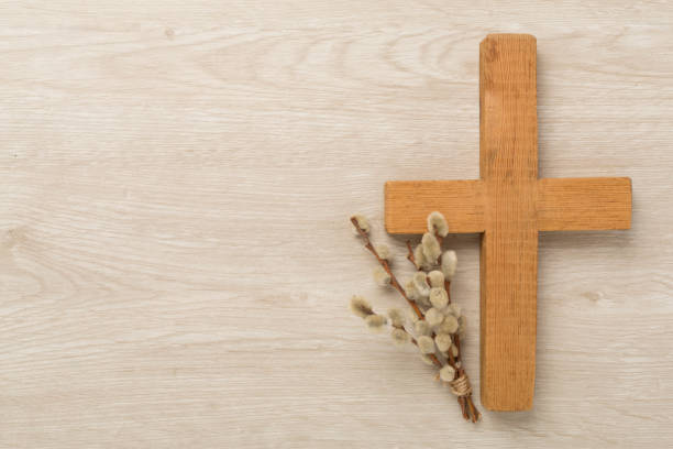 istock Cross with willow branches on wooden background, top, view. Palm Sunday concept 2118283342