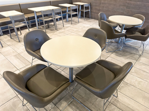 Tables and chairs in a fast food restaurant