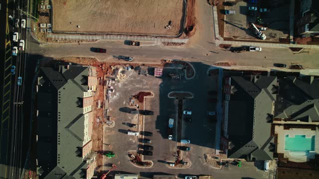 Construction residential houses in South Atlanta, Georgia, USA. Telescopic Boom Lift, scissor lift, dirty parking lot.