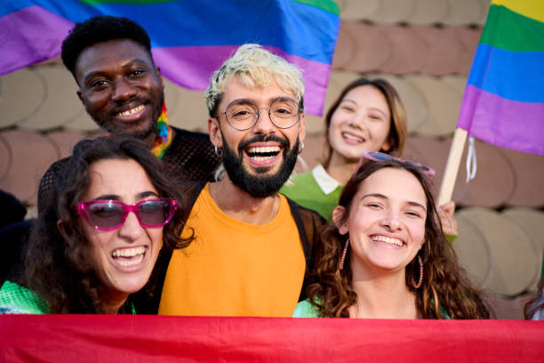 istock A group of people with smiling faces holding rainbow flags for a fun photograph 2118323254