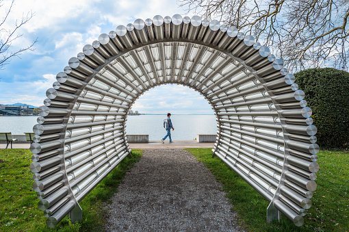 Bregenz, Austria - March 15, 2024: Tubular sculpture in the park and promenade by Lake Constance in Bregenz