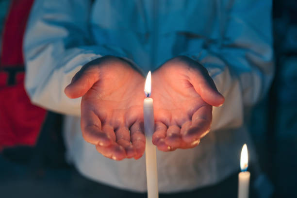 istock Woman hands holding burning candle 2118380911