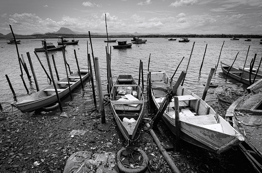 fishing boats moored waiting to be used. Photograph showing the harsh reality of fishermen