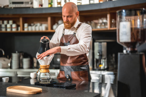 istock Caucasian Male's Professional Pour Over in a Cafeteria 2118410092