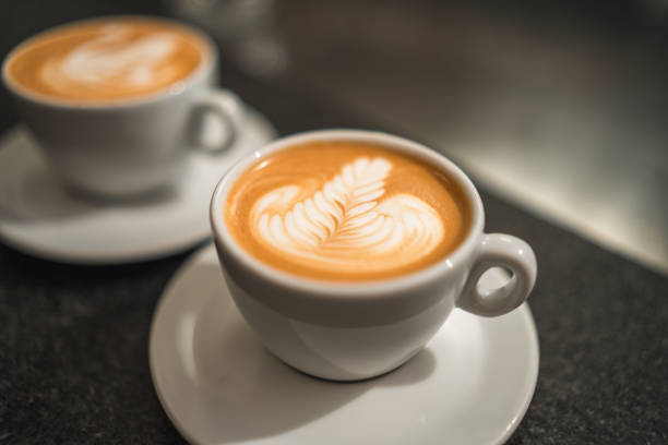 istock Coffee Cup with Intricate Latte Art in a Coffee House Setting 2118410689