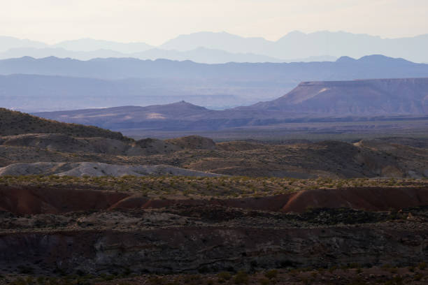 Typical rocky, hilly, sandy and arid stretch of colorful desert in Nevada, USA with cloudy sky. Copy space.