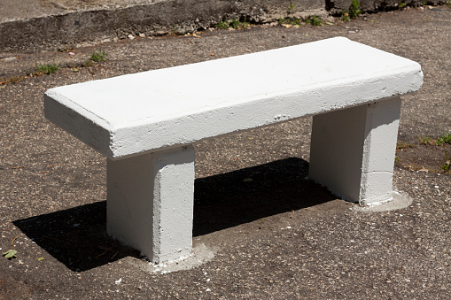 White painted concrete bench on a street in Lisbon, Portugal.
