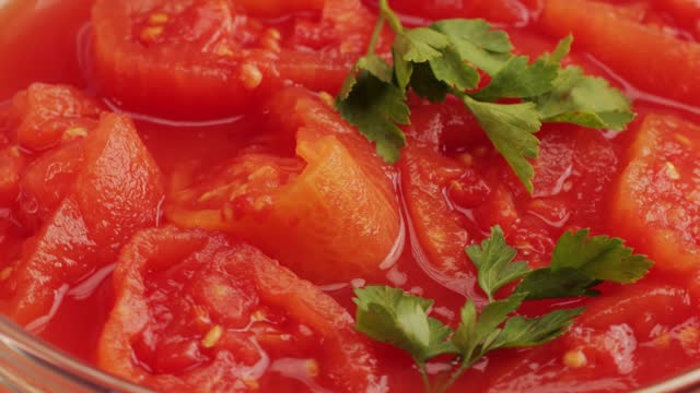 Peeled tomatoes texture, fresh canned tomato Juice sauce, bowl with peeled tomatoes in their own juice, Top view close up, Italian traditional cuisine food.