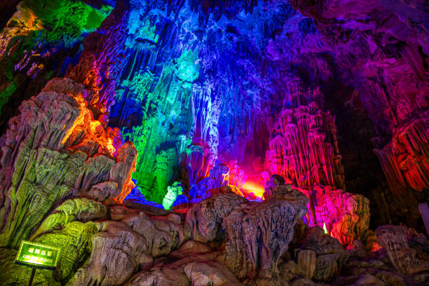 Inside the cave. Stalactites, stalagmites, colored light. Beautiful background. Reed flute cave Guilin China