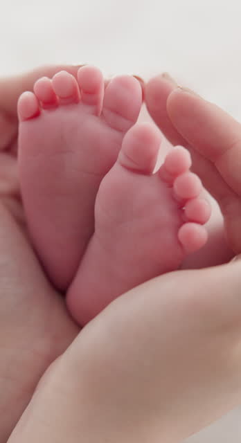 Baby, family and hands with feet on bed for bonding, love and relationship with infant. Adorable, cute and closeup of parent holding toes of newborn for support, wellness and protection at home