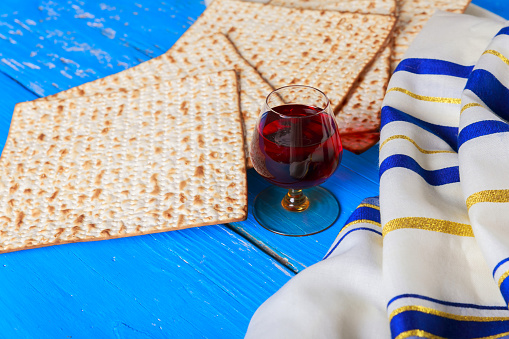 Jewish pesach attributes celebrated with kosher wine cup matzah flatbread unleavened bread during passover