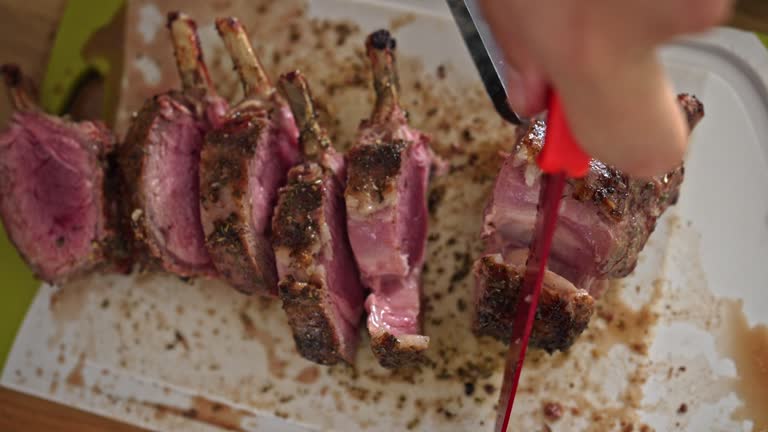 Slicing The Last Pieces Of The Lamb Rack - A Perfectly Roasted Delight Served On The Table