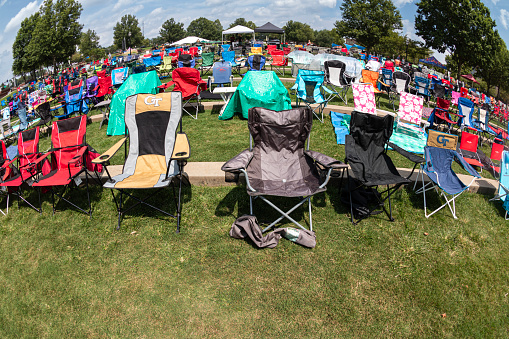 Suwanee, GA / USA - August 12, 2023:  Dozens of empty lawn chairs are set up for an outdoor summer concert at the Suwanee Town Park amphitheater, on August 12, 2023 in Suwanee, GA.