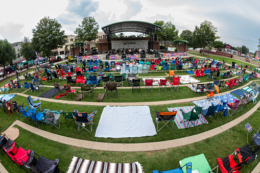 Suwanee, GA / USA - August 12, 2023:  Fisheye lens shows rows of empty lawn chairs set up for an outdoor concert at Suwanee Town Park, on August 12, 2023 in Suwanee, GA.