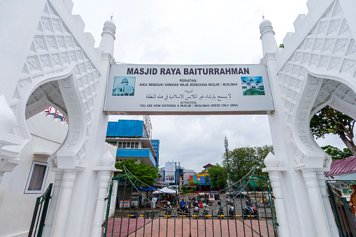 Banda Aceh-Indonesia. March 27, 2024.\n\nAt the main entrance to the Baiturrahman Mosque, there is a board that says \