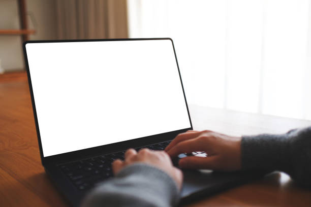 istock Mockup image of a woman working and typing on laptop computer with blank white desktop screen at home 2118734503
