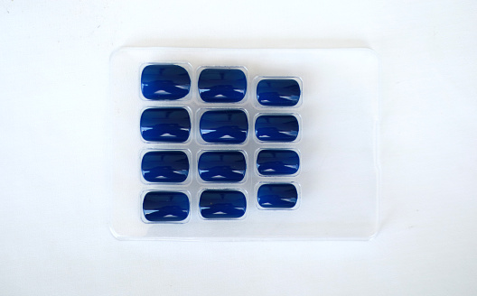 Blue fake nails on a white background.