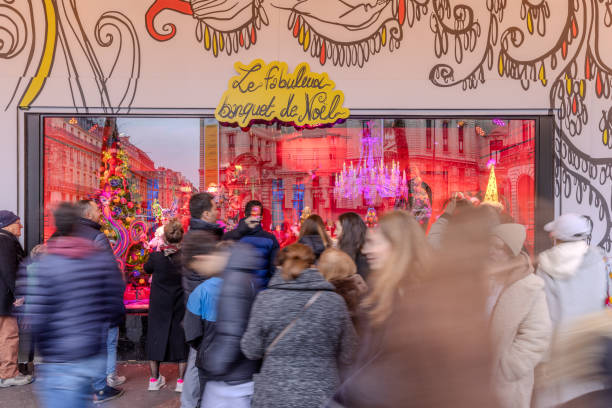 People walking past or admiring the beautiful window display of Galeries Lafayette in Paris, France on Christmas Day 2023