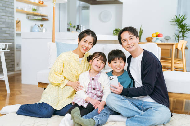 istock Close family looking at smartphone 2118801120