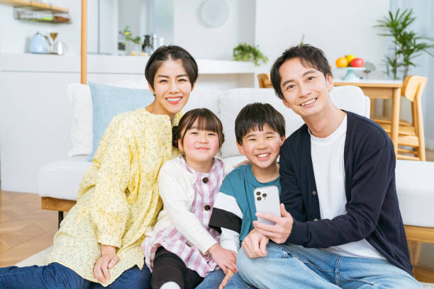 istock Close family looking at smartphone 2118801688