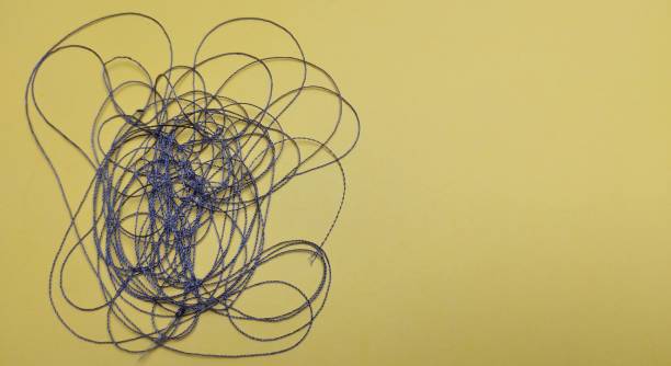 istock A coil of thread on a yellow background. Close-up. 2118851123