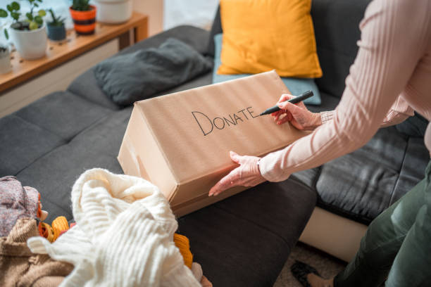 istock Senior Caucasian Couple Preparing Donation Box with Clothes 2118900904