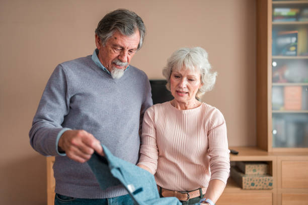 istock Senior Caucasian Couple Sorting Clothes for Donation 2118900922