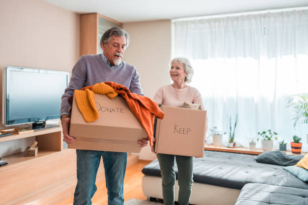 istock Senior Caucasian Couple Organizing Clothes Donation Indoors 2118900923
