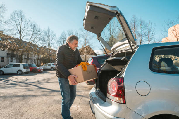 istock Senior Caucasian Male Loading Donating Clothes in a Car 2118900953