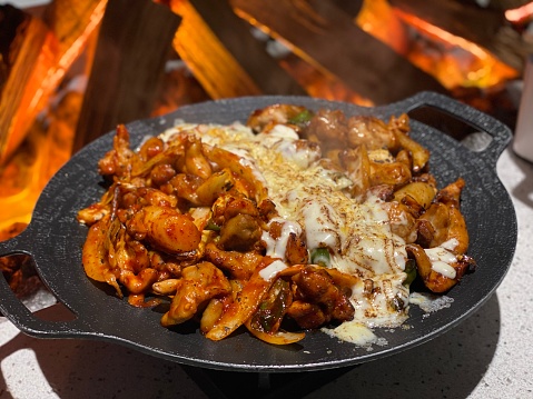 Spicy Stir-fried Chicken in front of burning firewood (Korean food)