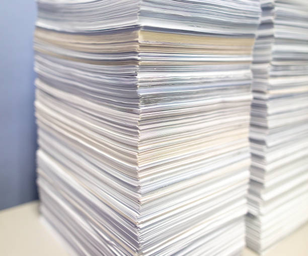 istock Stacks of papers on a table in the office 2118995557