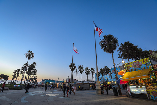 Los Angeles, CA, USA - August 22, 2017: The Venice Boardwalk at dusk on a summer day.